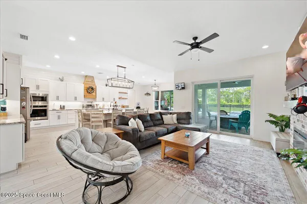 a kitchen with stainless steel appliances granite countertop a stove and a wooden floors