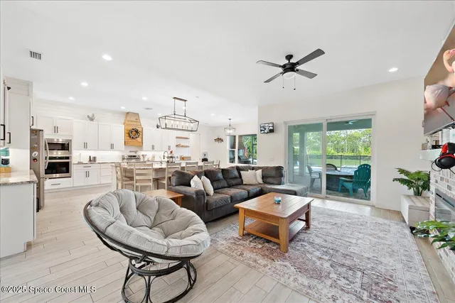 a kitchen with stainless steel appliances granite countertop a stove and a wooden floors