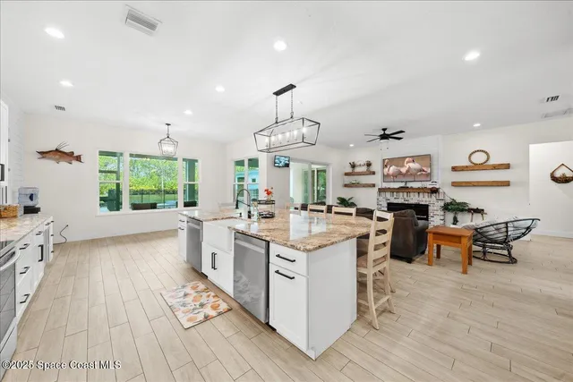 a kitchen with stainless steel appliances granite countertop a stove and a sink