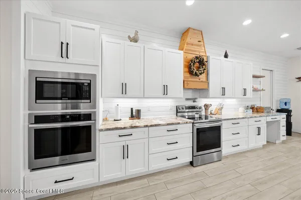 a view of a dining room with furniture wooden floor and chandelier