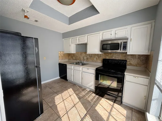 a kitchen with stainless steel appliances a stove a microwave and a refrigerator