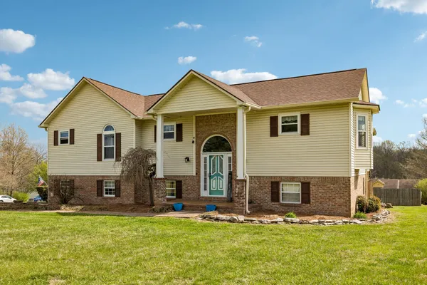 a front view of a house with a yard