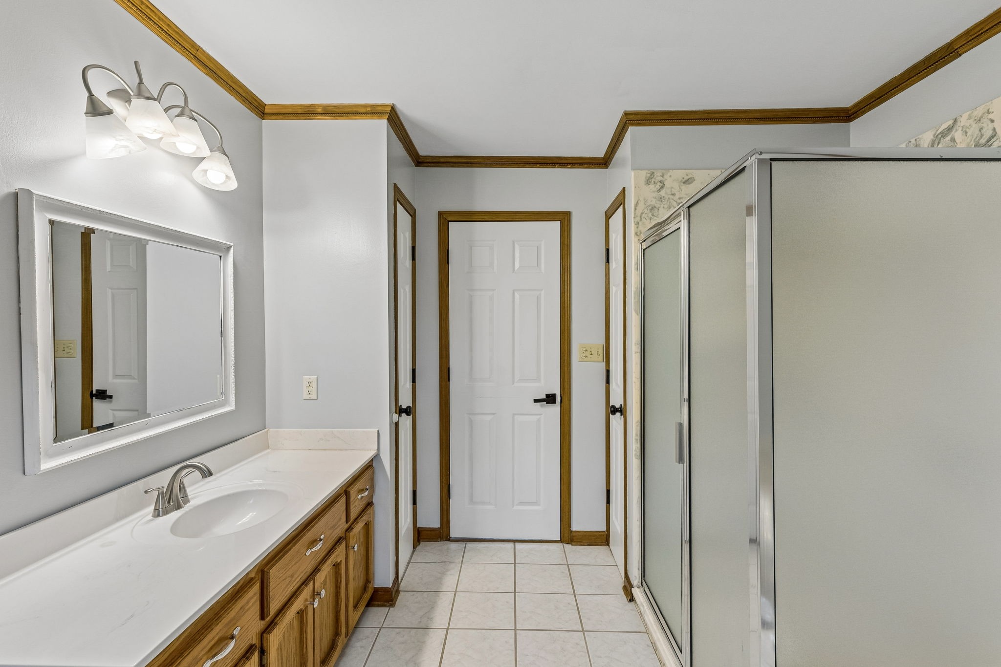 97 Oak Valley Drive Spring Hill, TN 37174 - Photo 34 of 40 a bathroom with a sink a mirror a vanity and a shower