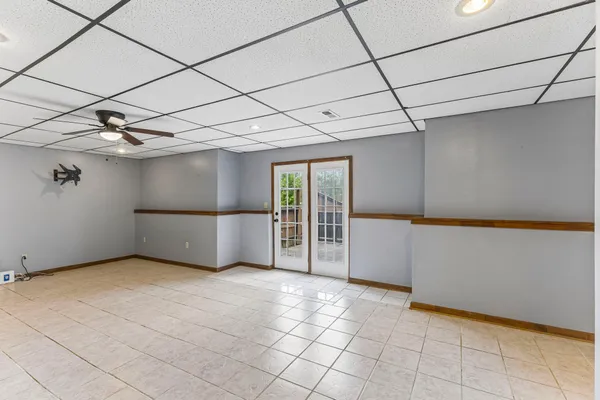 a view of a livingroom with an empty space and a refrigerator