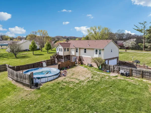 an aerial view of a house with garden space and street view