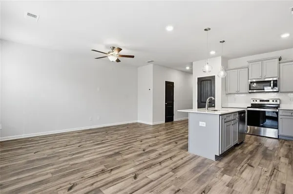 a kitchen with stainless steel appliances a refrigerator sink and stove