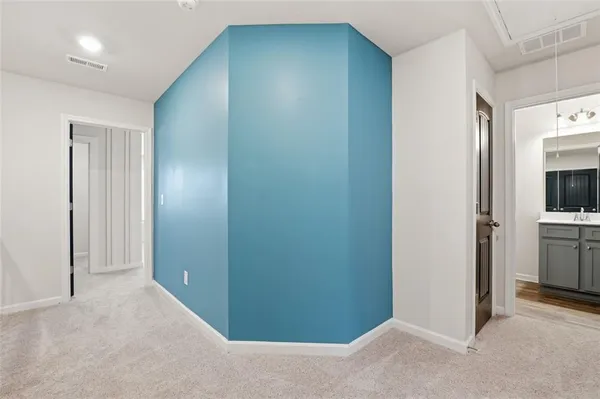 a view of hallway with bathroom