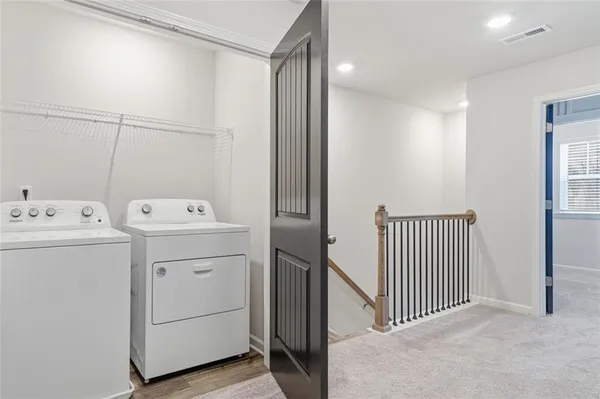 a view of storage and utility room with dryer and washer
