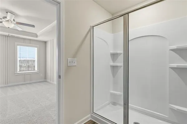 a bathroom with a glass shower door