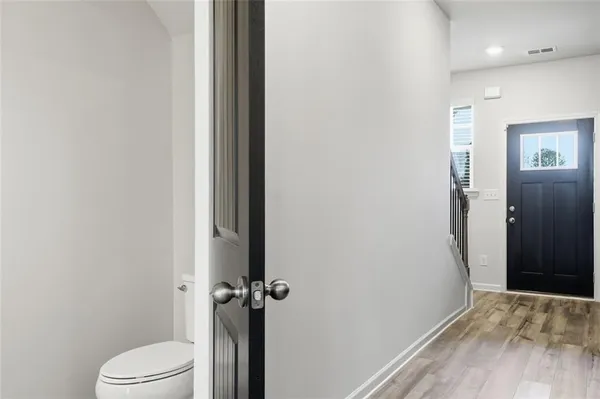 a bathroom with a granite countertop toilet and a sink