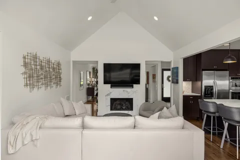 a large bedroom with a large bed and wooden floor