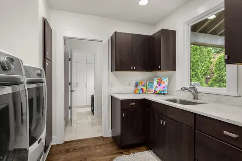 a view of an house with swimming pool and chairs