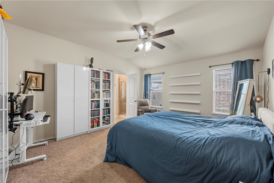 11220 Haviture Way Waco, TX 76708 - Photo 13 of 23 a bedroom with a large bed and a chandelier