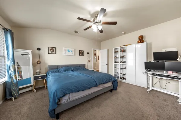 a bedroom with a bed furniture and a flat screen tv