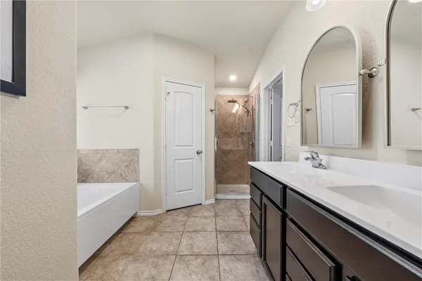 a bathroom with a sink a mirror and a bathtub