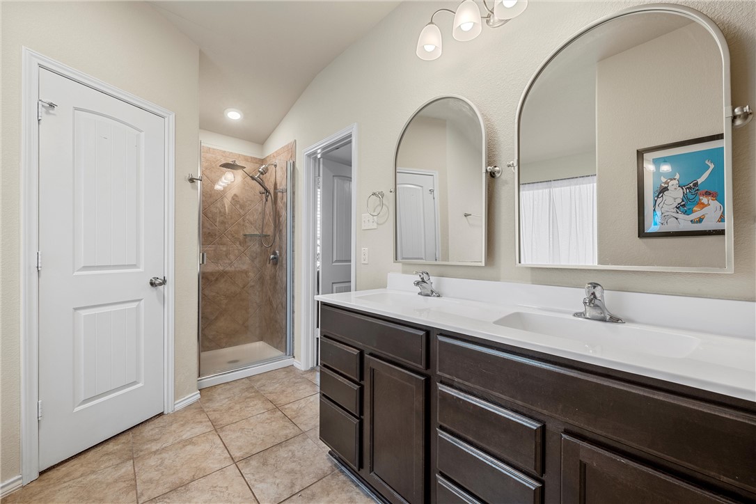 11220 Haviture Way Waco, TX 76708 - Photo 17 of 23 a spacious bathroom with a double vanity sink and a mirror