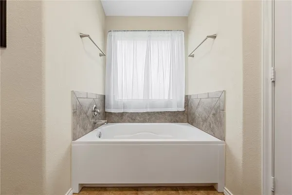 a white bath tub sitting in a bathroom