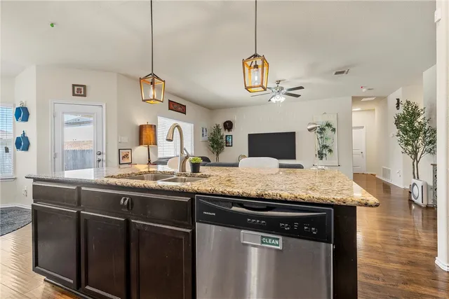 a kitchen with a counter space a sink and appliances
