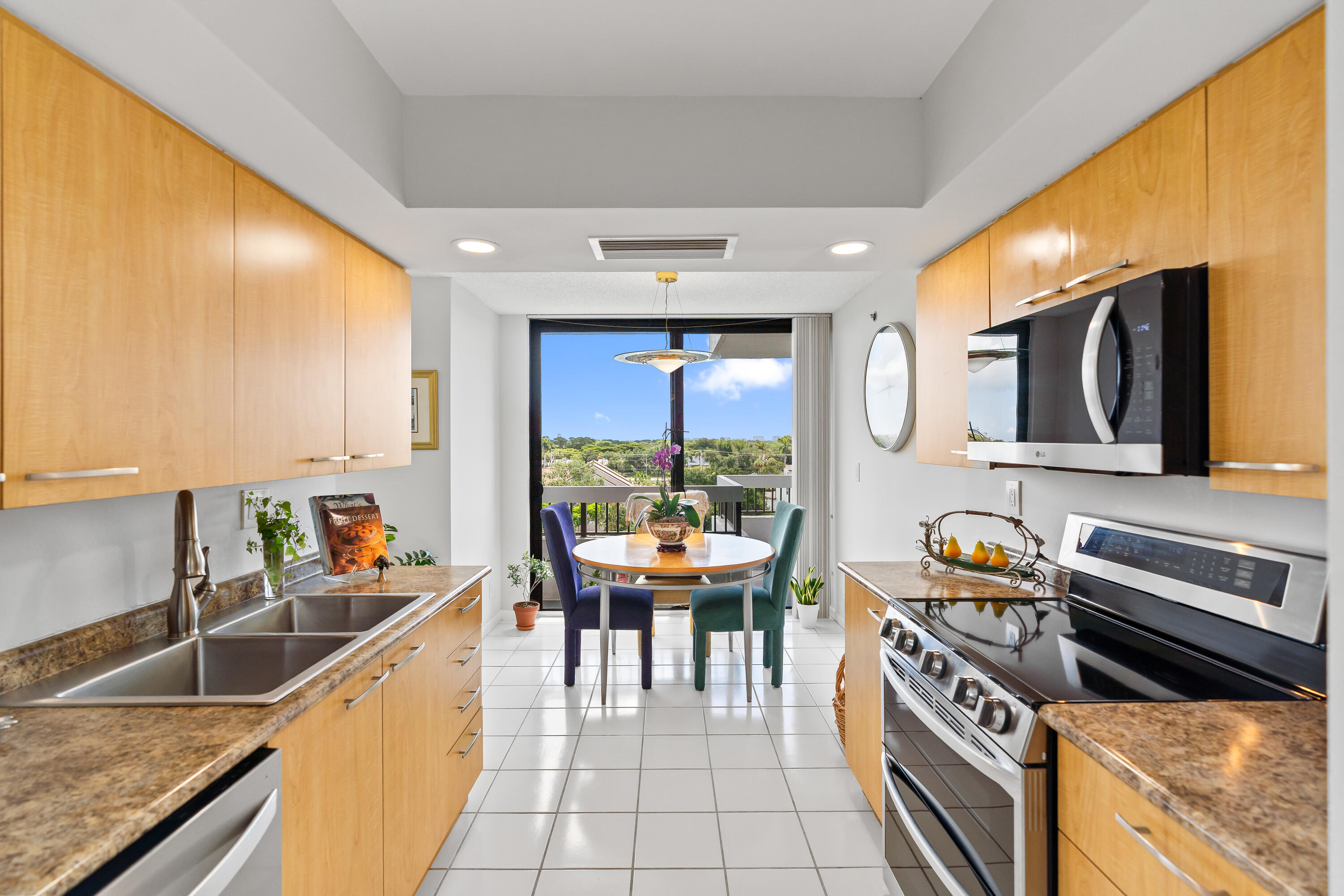 23200 Camino Del Mar, Unit 603 Boca Raton, FL 33433 - Photo 10 of 43 a kitchen with stainless steel appliances granite countertop a sink and a stove