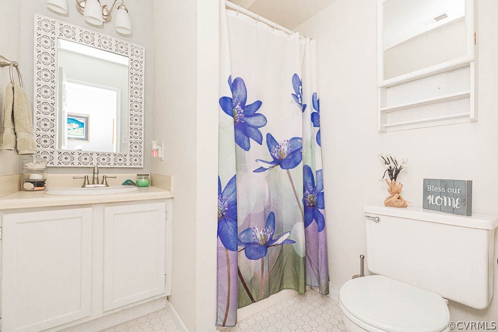 5817 Mill Spring Road Midlothian, VA 23112 - Photo 16 of 29 a bathroom with a sink mirror vanity and toilet