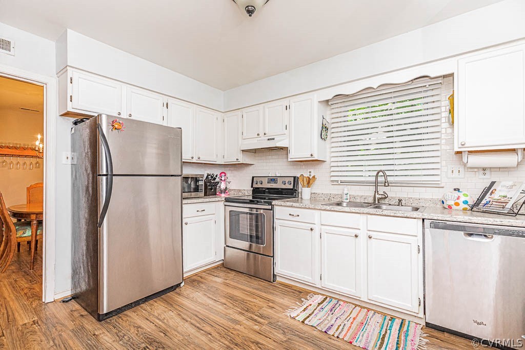 5817 Mill Spring Road Midlothian, VA 23112 - Photo 3 of 29 a kitchen with stainless steel appliances a refrigerator sink and cabinets