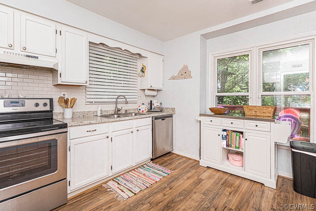 5817 Mill Spring Road Midlothian, VA 23112 - Photo 4 of 29 a kitchen with a sink stove and cabinets