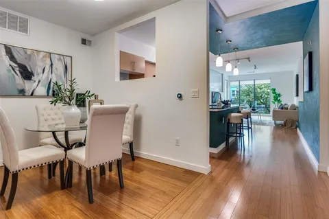 a view of a dining room with furniture and wooden floor