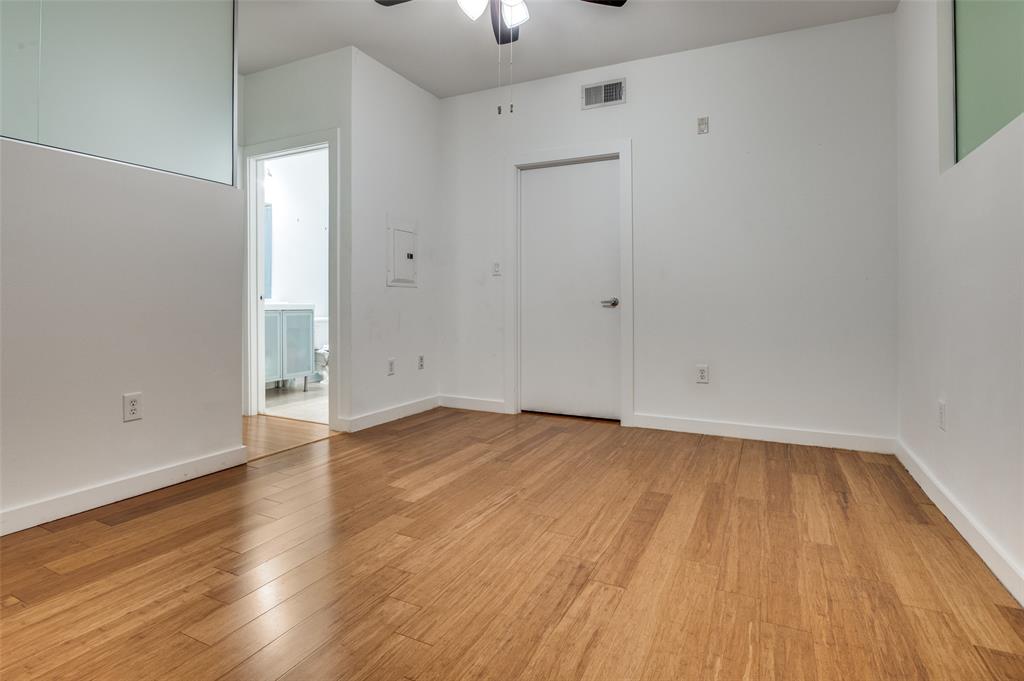 4040 North Hall Street, Unit 105 Dallas, TX 75219 - Photo 14 of 25 a view of an empty room with wooden floor