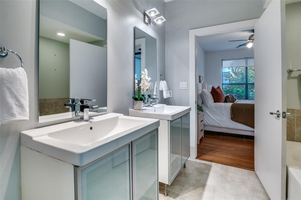 4040 North Hall Street, Unit 105 Dallas, TX 75219 - Photo 19 of 25 a bathroom with a sink and a mirror