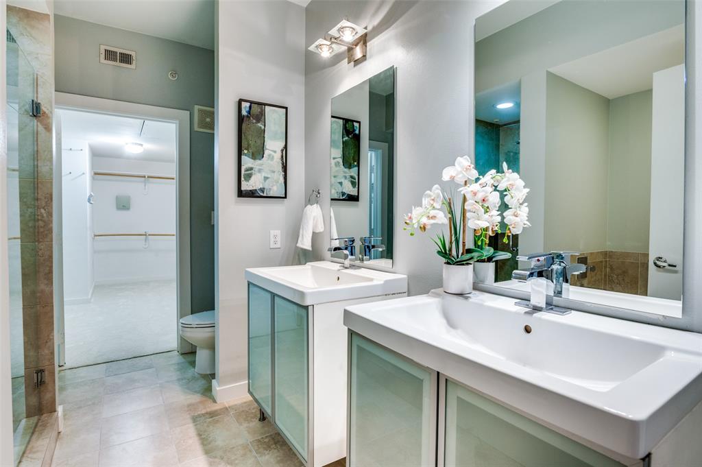 4040 North Hall Street, Unit 105 Dallas, TX 75219 - Photo 20 of 25 a bathroom with a sink and a mirror
