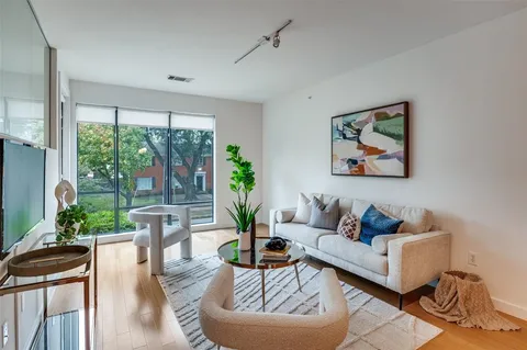 a living room with furniture large window and outer view