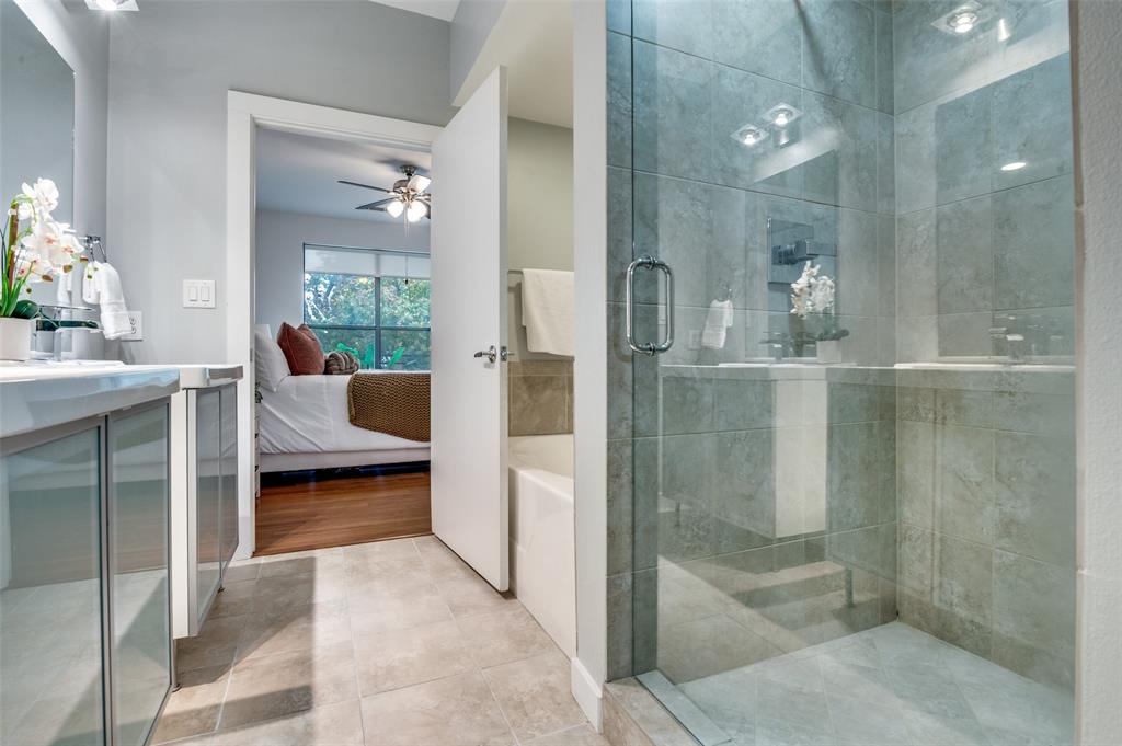 4040 North Hall Street, Unit 105 Dallas, TX 75219 - Photo 21 of 25 a room with a glass door shower and a sink