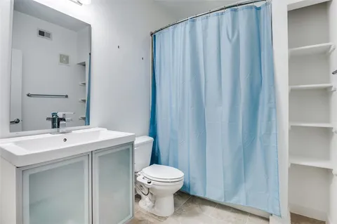 a bathroom with a toilet a sink and a mirror