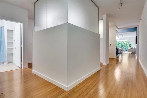 a view of a hallway with wooden floor