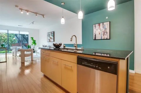 a kitchen with stainless steel appliances granite countertop a stove and a sink