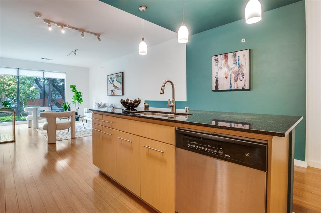 4040 North Hall Street, Unit 105 Dallas, TX 75219 - Photo 9 of 25 a kitchen with stainless steel appliances granite countertop a stove and a sink
