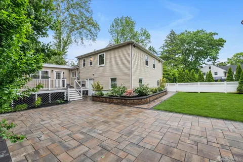 a view of house with backyard and garden