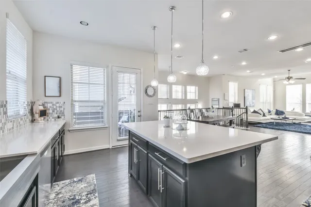 a kitchen with center island a sink appliances and living room view