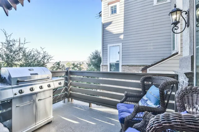a view of roof deck with wooden floor and seating space