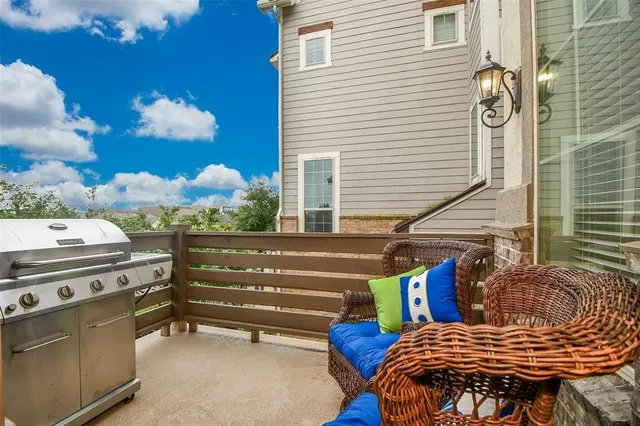 a view of a balcony with furniture and a potted plant