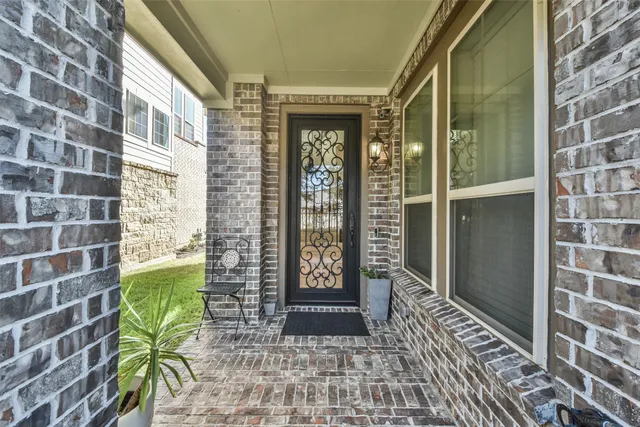 a view of front door of house with glass door