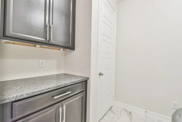 a view of a microwave and cabinets