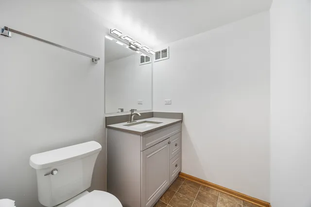 a bathroom with a sink toilet and vanity