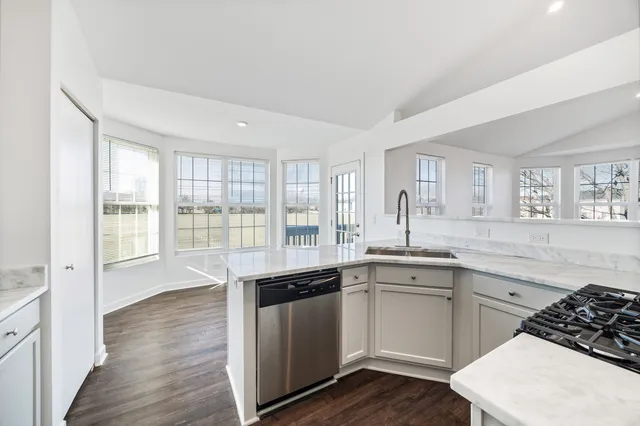 a kitchen with a sink stove and wooden cabinets