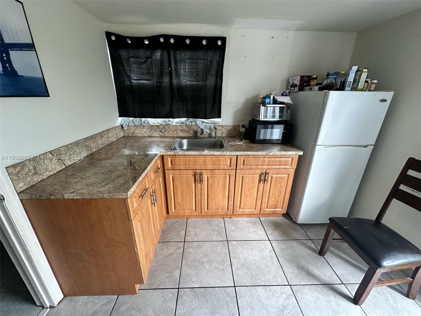 2131 Southwest 98th Place Miami, FL 33165 - Photo 15 of 22 a kitchen with stainless steel appliances granite countertop a sink and a refrigerator
