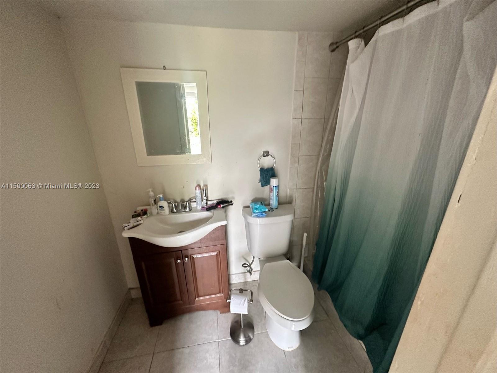 2131 Southwest 98th Place Miami, FL 33165 - Photo 16 of 22 a bathroom with a sink toilet and shower