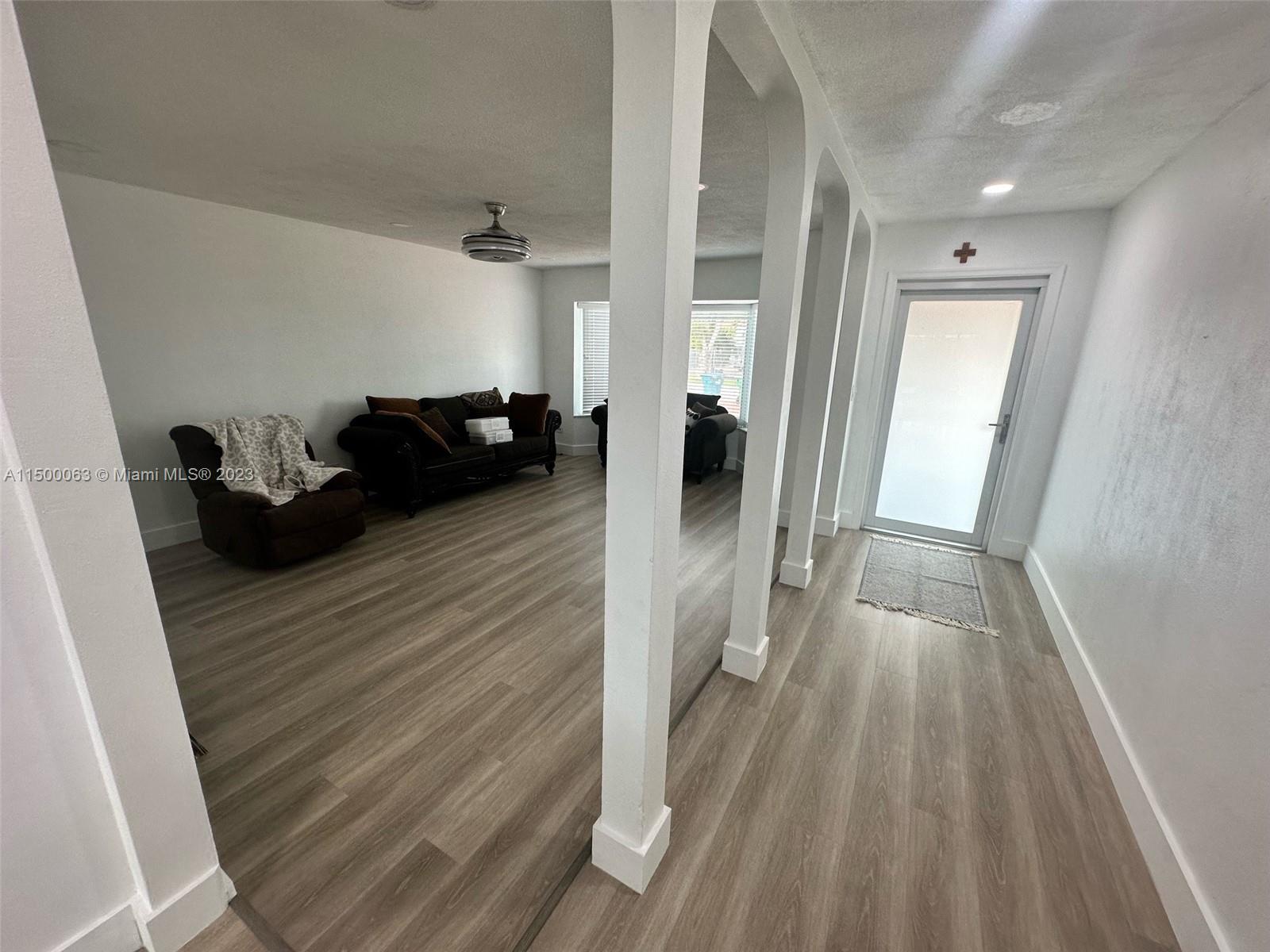 2131 Southwest 98th Place Miami, FL 33165 - Photo 6 of 22 a view of a hallway view with wooden floor and furniture