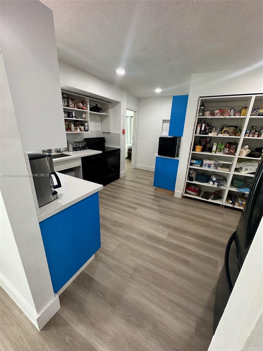 2131 Southwest 98th Place Miami, FL 33165 - Photo 10 of 22 a view of kitchen with sink microwave and refrigerator