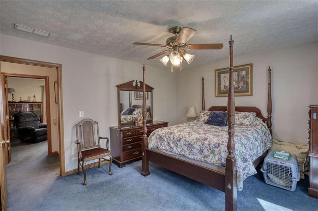 2740 Dennard Road Northeast Conyers, GA 30013 - Photo 30 of 51 a bedroom with a bed a chandelier and dresser