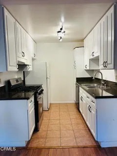 a kitchen with a sink and a stove top oven